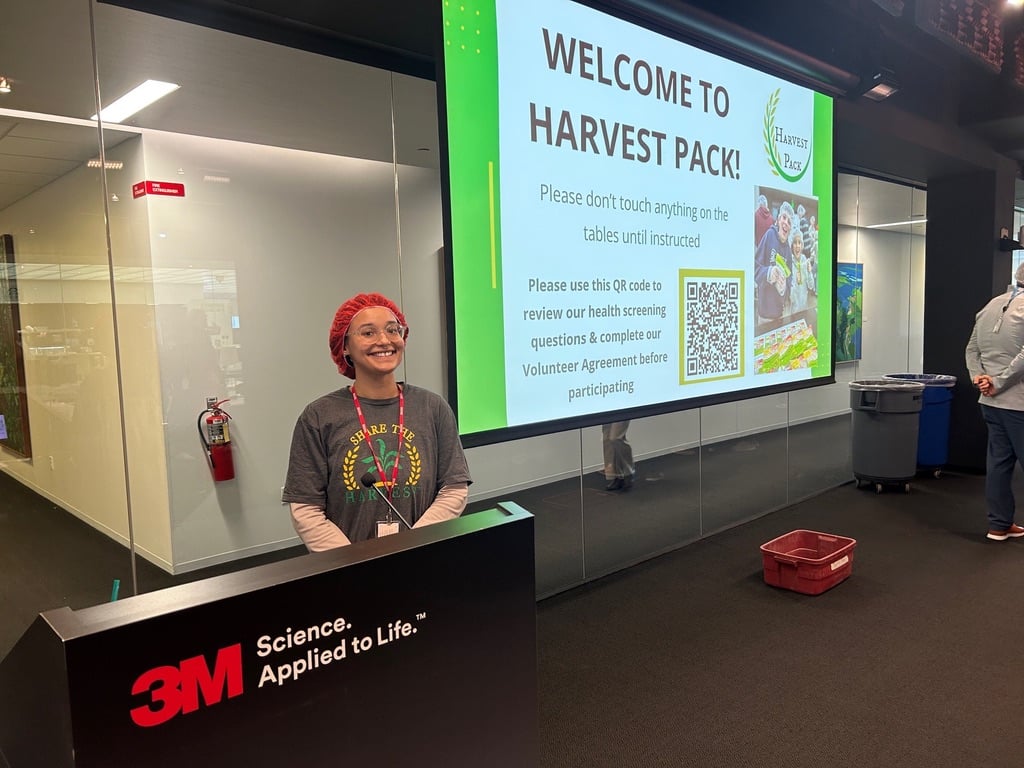 Harvest Pack event leader smiling and ready to start the event presentation.