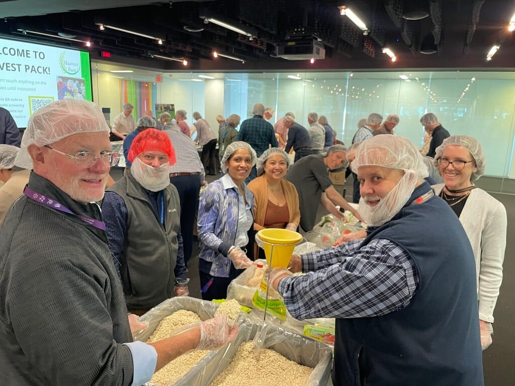 3M employee volunteers smiling at their assembly line.