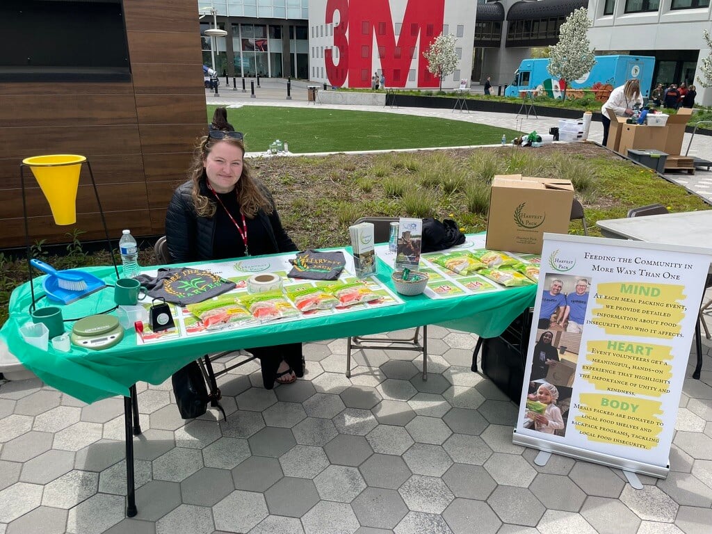 Harvest Pack team member representing the organization at the volunteer fair, sharing merch, resources, and opportunities to provide healthy food on every table.